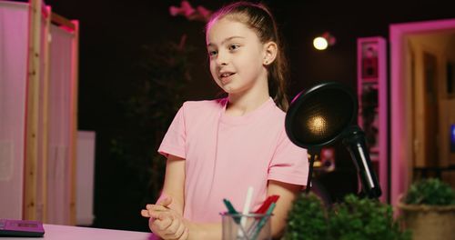 Portrait of young woman sitting on table