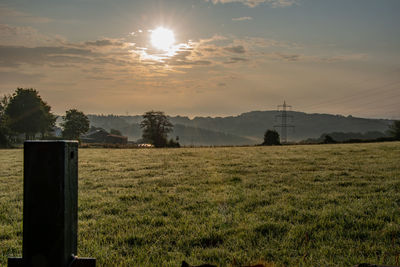 Scenic view of field against sky during sunset