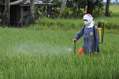 Crop sprayer spraying on field