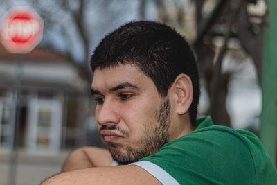 Close-up portrait of young man looking away