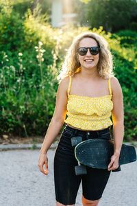 Young woman wearing sunglasses standing outdoors