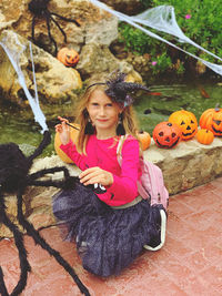 Portrait of smiling girl holding umbrella