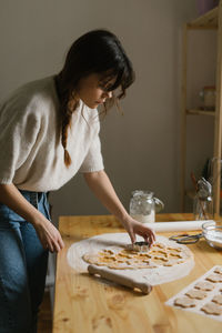 Young woman making christmas cookies