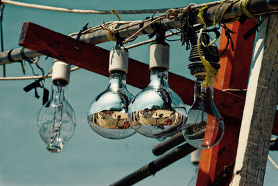 Low angle view of light bulbs at fishing boat