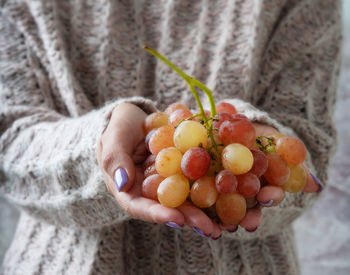 Close-up of hand holding strawberries