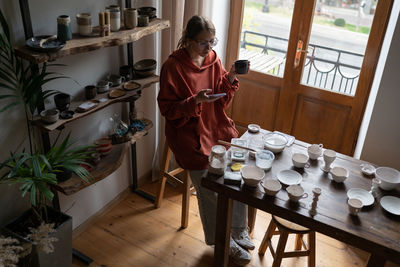 Portrait of woman sitting on table