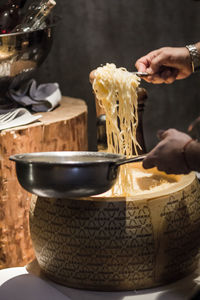 Cropped image of chef cooking noodles