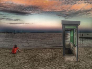 Lifeguard hut in front of sea during sunset