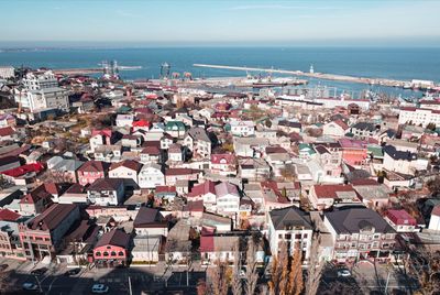 High angle view of townscape by sea against sky