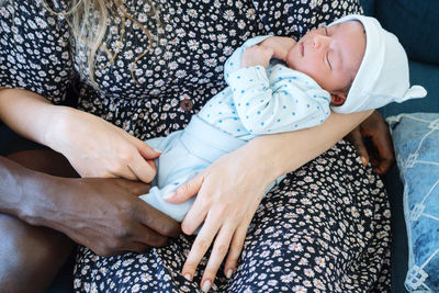 Mixed race couple holding their newborn baby