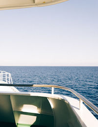 Close-up of boat sailing in sea against clear sky