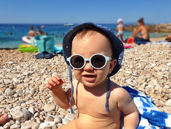 Portrait of cute little baby on the beach