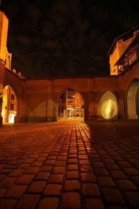 Illuminated tunnel at night