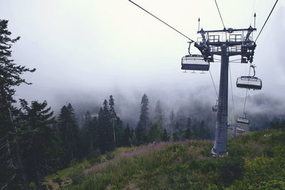 Low angle view of ski lift against sky