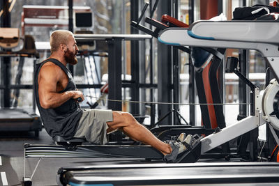 Side view of man exercising in gym