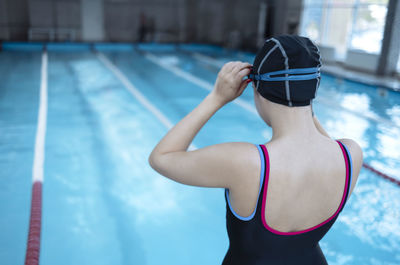 Rear view of woman exercising in gym