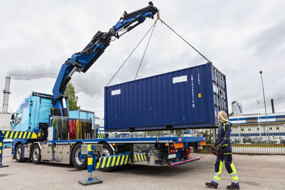 Woman assisting with carrying cargo container