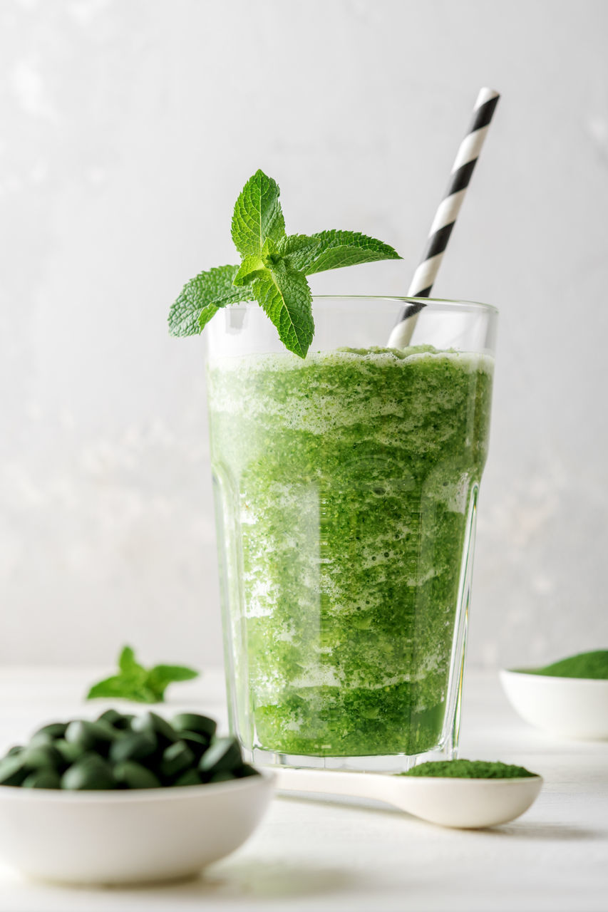 GREEN FRUIT ON TABLE AGAINST GLASS