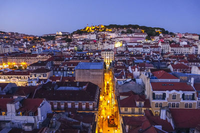 High angle view of buildings in city at night