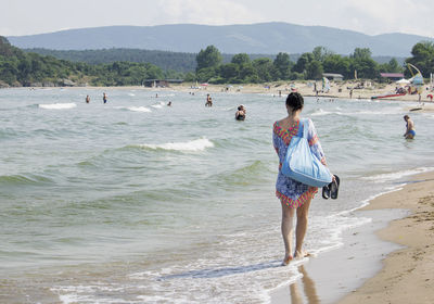 Rear view of women on beach