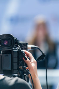 Cropped hand holding camera