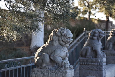 Statue against trees