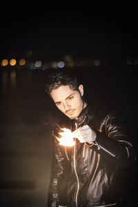 Young man looking away at night