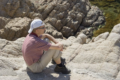 High angle view of man sitting on mountain