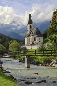 Church by building against sky