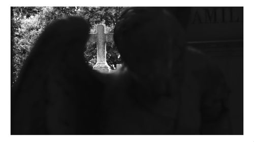 Rear view of silhouette women standing against blurred background