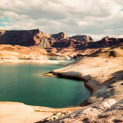 Scenic view of lake and mountains against sky