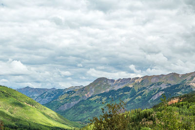 Scenic view of mountains against cloudy sky