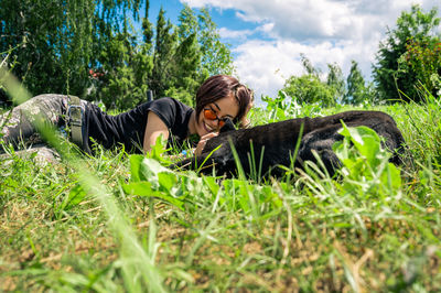 Side view of woman sitting on field