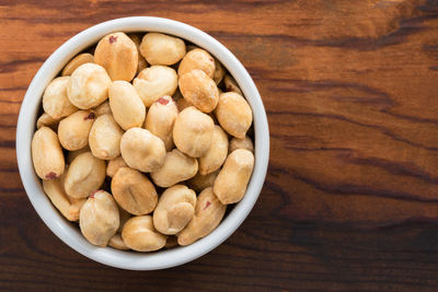 High angle view of peanuts in bowl on table