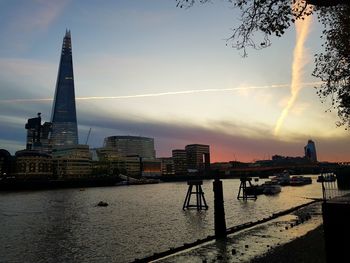 View of city at waterfront during sunset