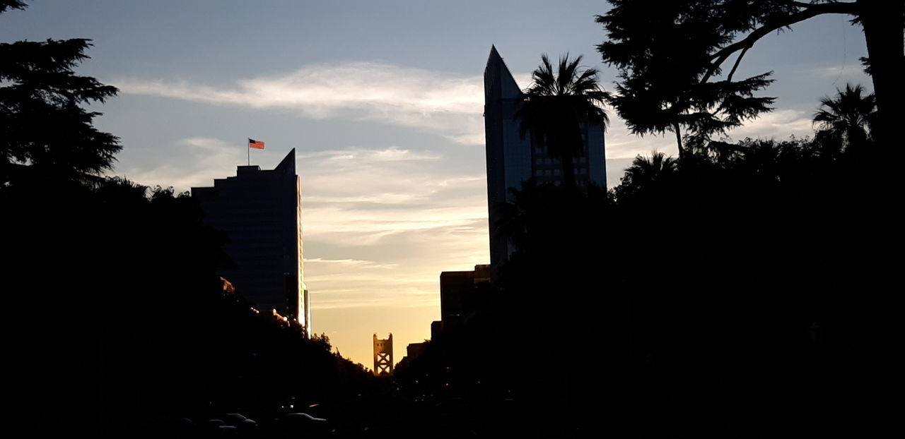 LOW ANGLE VIEW OF SILHOUETTE BUILDING AGAINST SKY