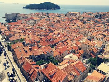 High angle view of townscape by sea against sky