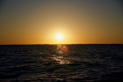 Scenic view of sea against clear sky during sunset