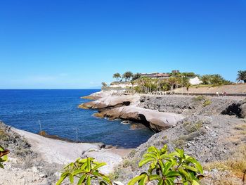 Scenic view of sea against clear blue sky