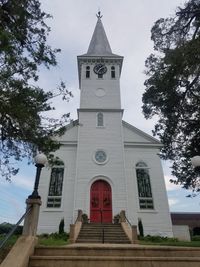 Low angle view of clock tower against sky