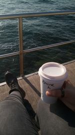 Low section of person with coffee in sea