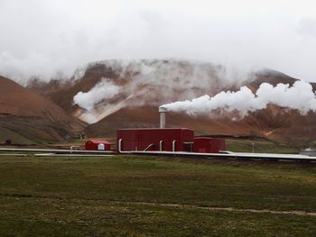 Smoke emitting from chimney against sky