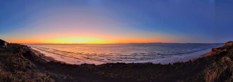 Scenic view of beach against sky during sunset