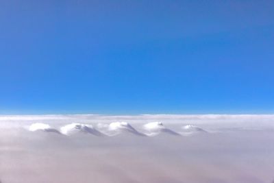 Scenic view of snow against clear blue sky