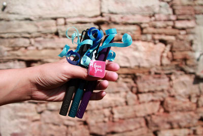 Close-up of hand holding multi colored finger