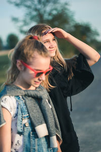 Friends standing on road in city