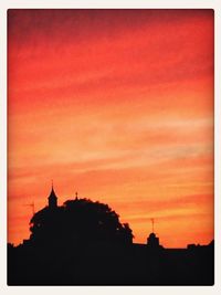 Silhouette of building at sunset