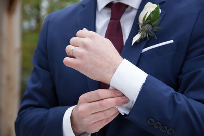 Midsection of couple holding hands