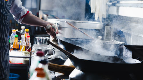 Midsection of man preparing food in kitchen