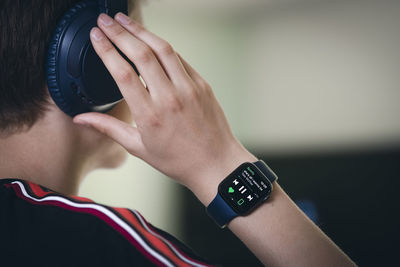 View of person listening to music via smart watch